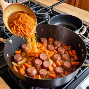 Рецепт Кулеш с колбасками и перловкой - Обжарка лука, моркови и колбасок