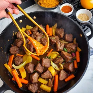 Рецепт Плов с бараниной и хурмой - Обжарка мяса и овощей