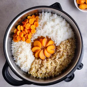 Рецепт Плов с говядиной и курагой - Добавление риса и кураги