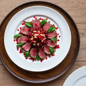 Карпаччо из зубчатки с гранатовым соусом и кедровыми орешками